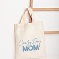 Beige tote bag with 'Crazy Dog Mom' text on a white background