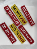 Set of six dog training signs with messages like 'Do Not Pet', 'In Training', and 'Give Us Space' on a white background.