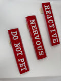 Three red straps with white text on a white background