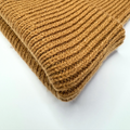 Folded brown knitted fabric on a white background