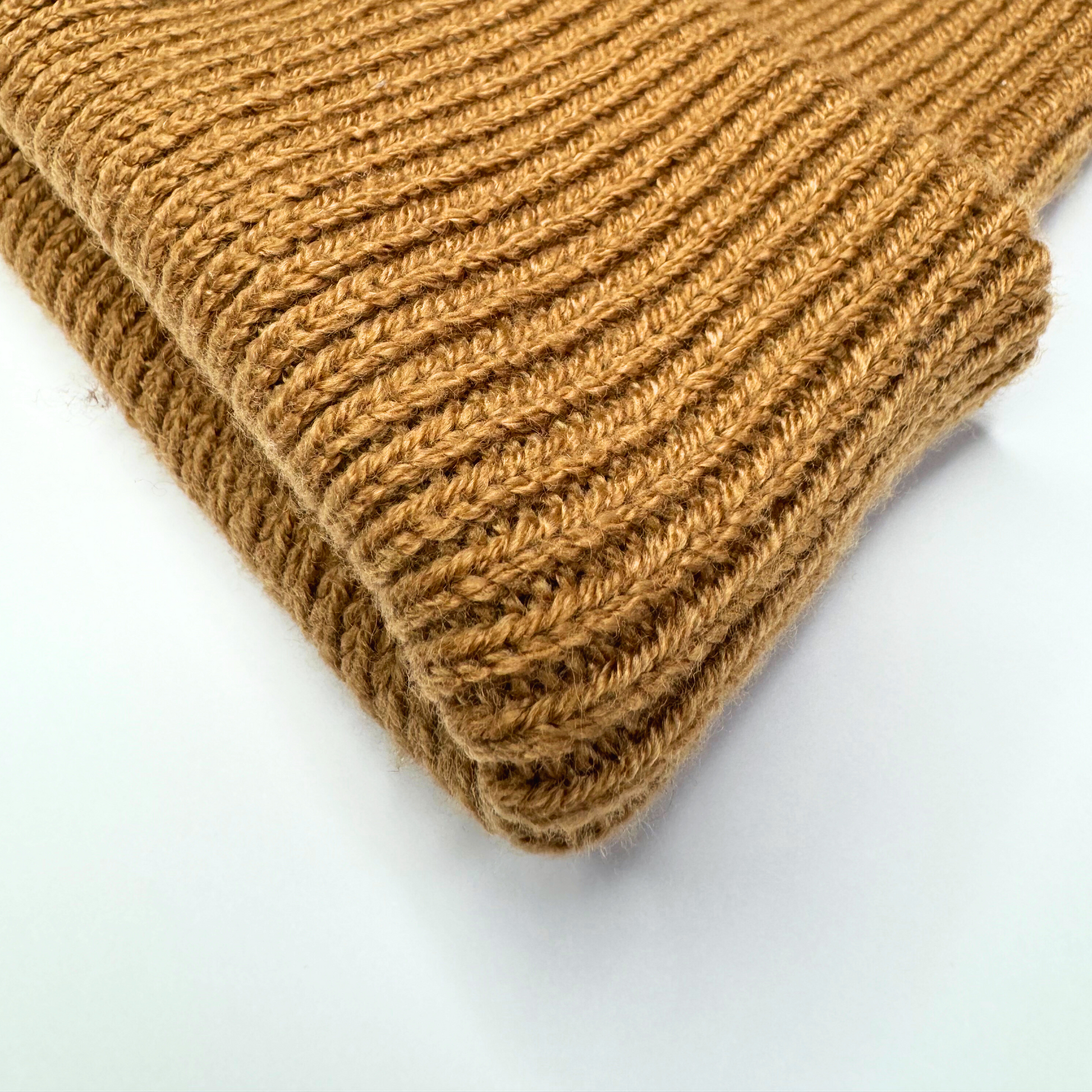 Folded brown knitted fabric on a white background