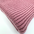 Close-up of a pink knitted fabric on a white background