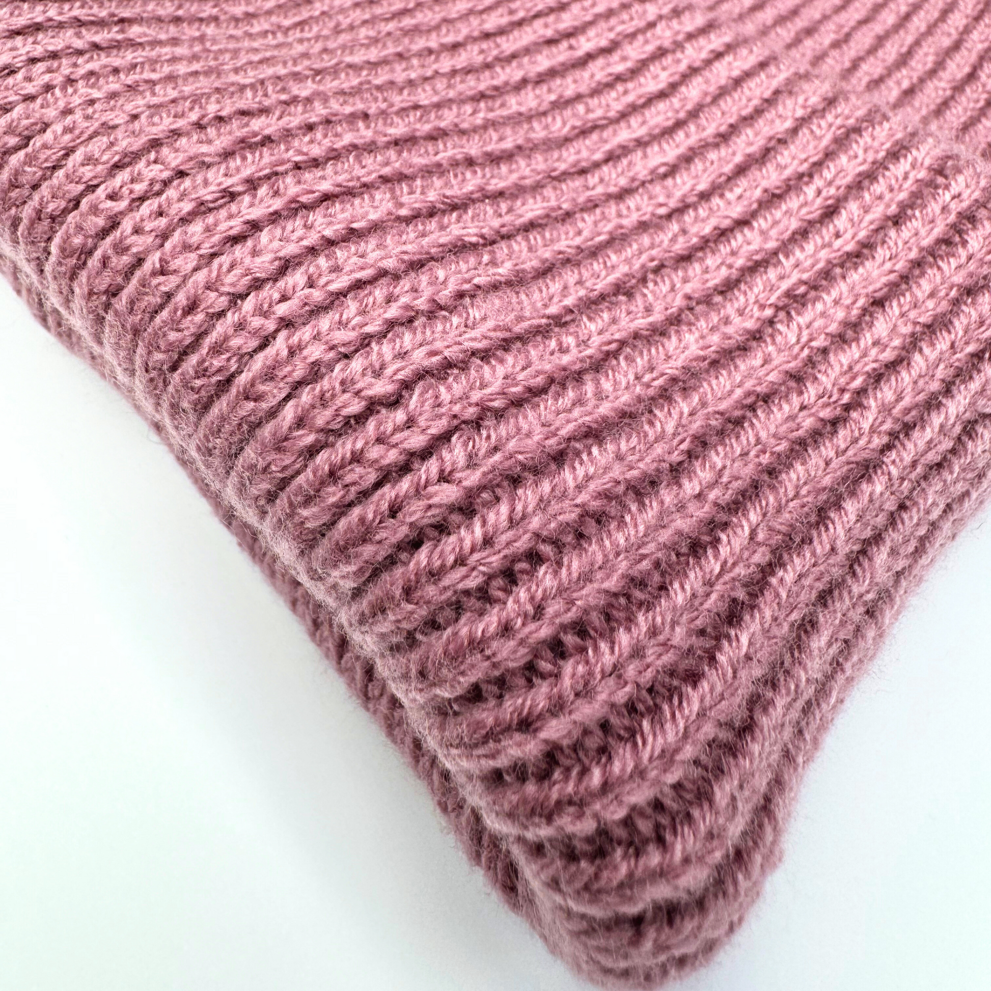 Close-up of a pink knitted fabric on a white background