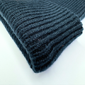 Dark gray ribbed knit fabric on a white background