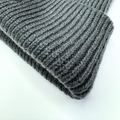 Stack of gray knit fabric on a white background
