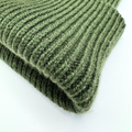 Folded green knitted fabric on a white background
