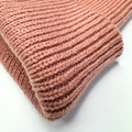 Close-up of a pink knitted fabric on a white background