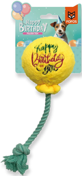 A yellow plush ball dog toy with 'Happy Birthday you' written on it in red and green, attached to a green twisted rope, shown on its retail backing card. The card features the FOFOS brand logo and a picture of a dog.